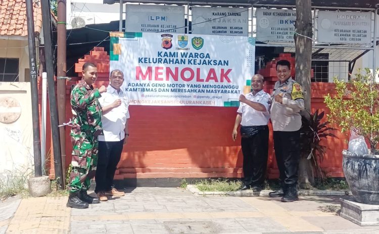 Sinergitas TNI-Polri : Babinsa dan Bhabinkamtibmas Dampingi Lurah Kejaksan Pasang Spanduk Penolakan Geng Motor