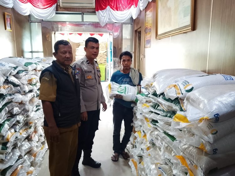 Anggota Polsek Balaraja Polresta Tangerang Pantau Bantuan Pangan Beras Bulog Juni & Juli 2025 di Aula Desa Cangkudu